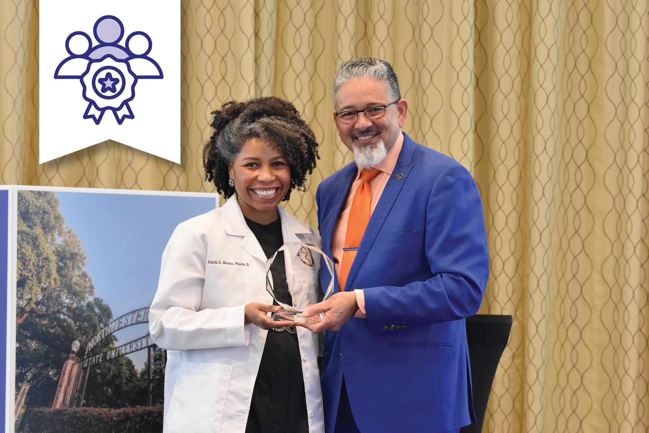 Dr. Rick Gallot presenting the Agent of Change award to Dr. Alexis Horace, University of Louisiana at Monroe.
